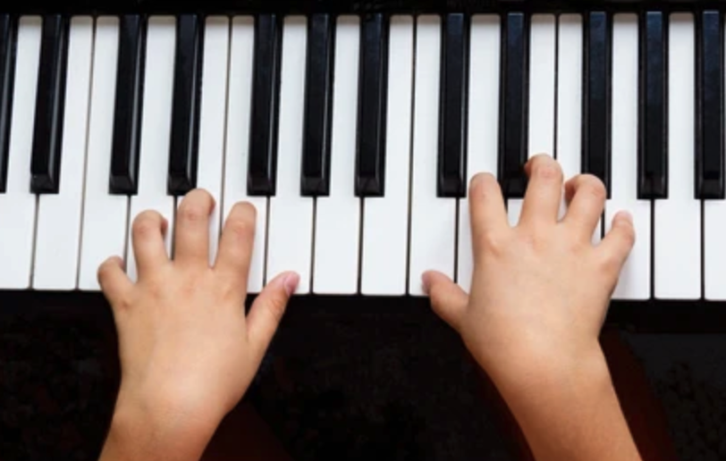 Photo of child playing piano 
